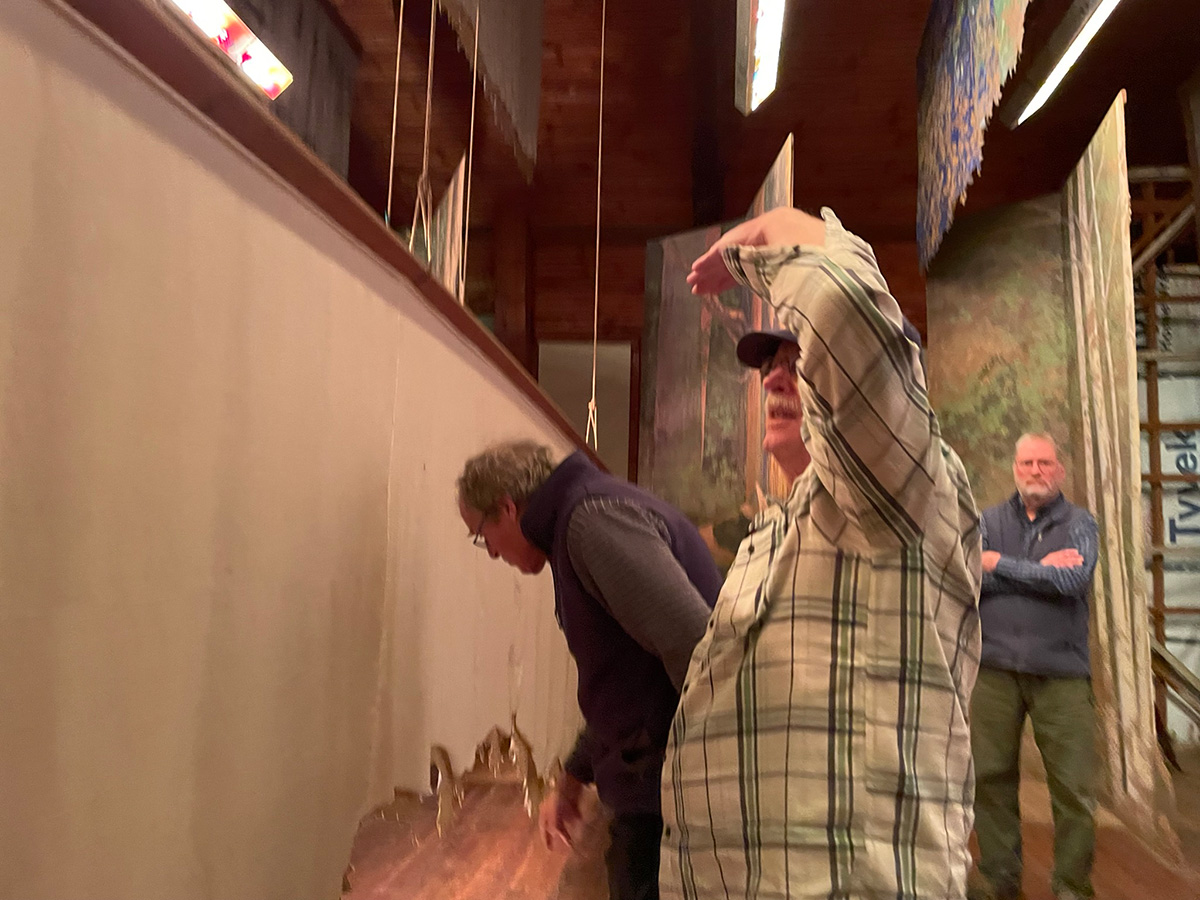 Examining-one-of-the-three-overhead-drapes